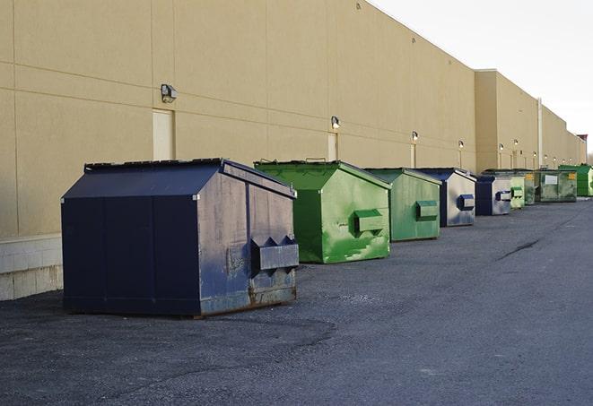 a stack of yellow construction dumpsters on a job site in Hooper